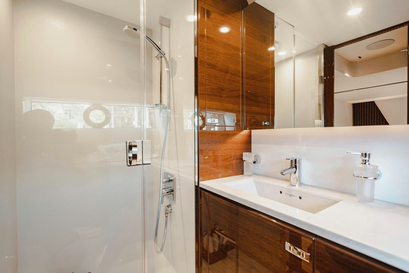 a bathroom with a glass shower aboard KAOS Yacht for Sale