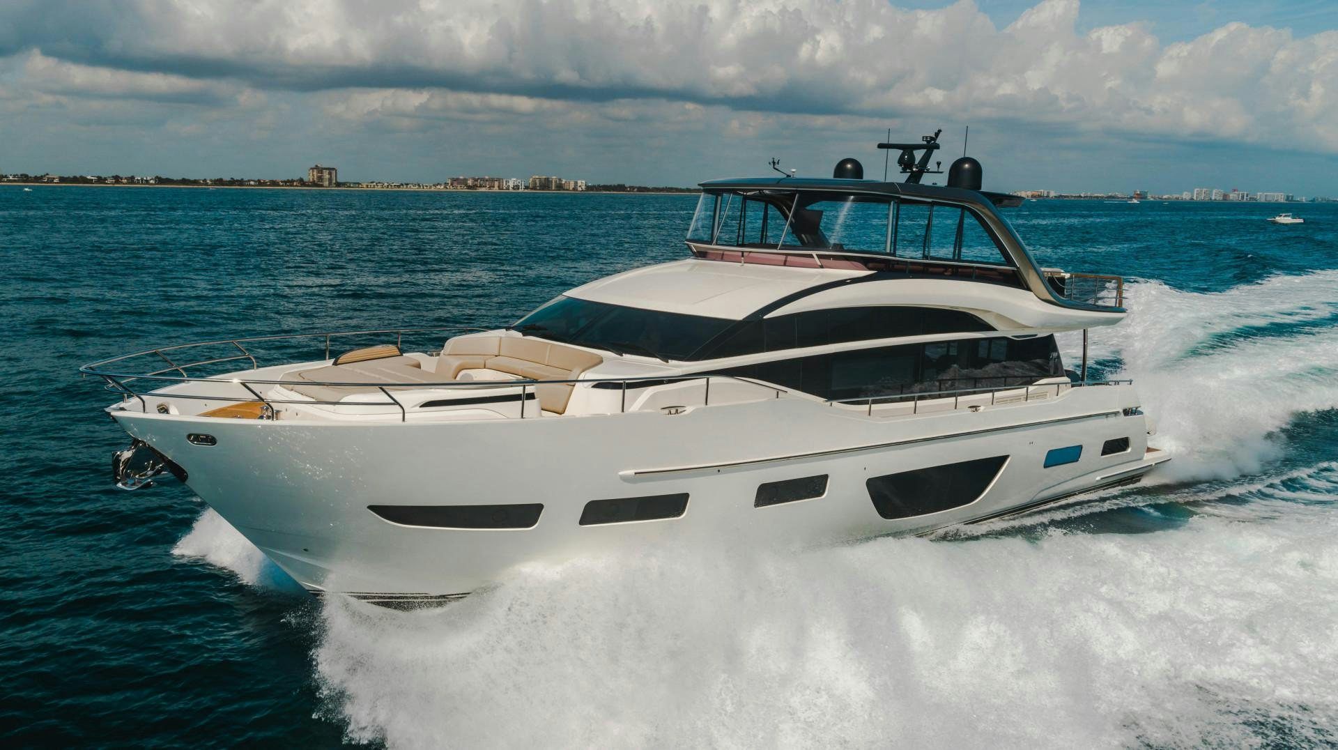 a white boat on the water aboard KAOS Yacht for Sale