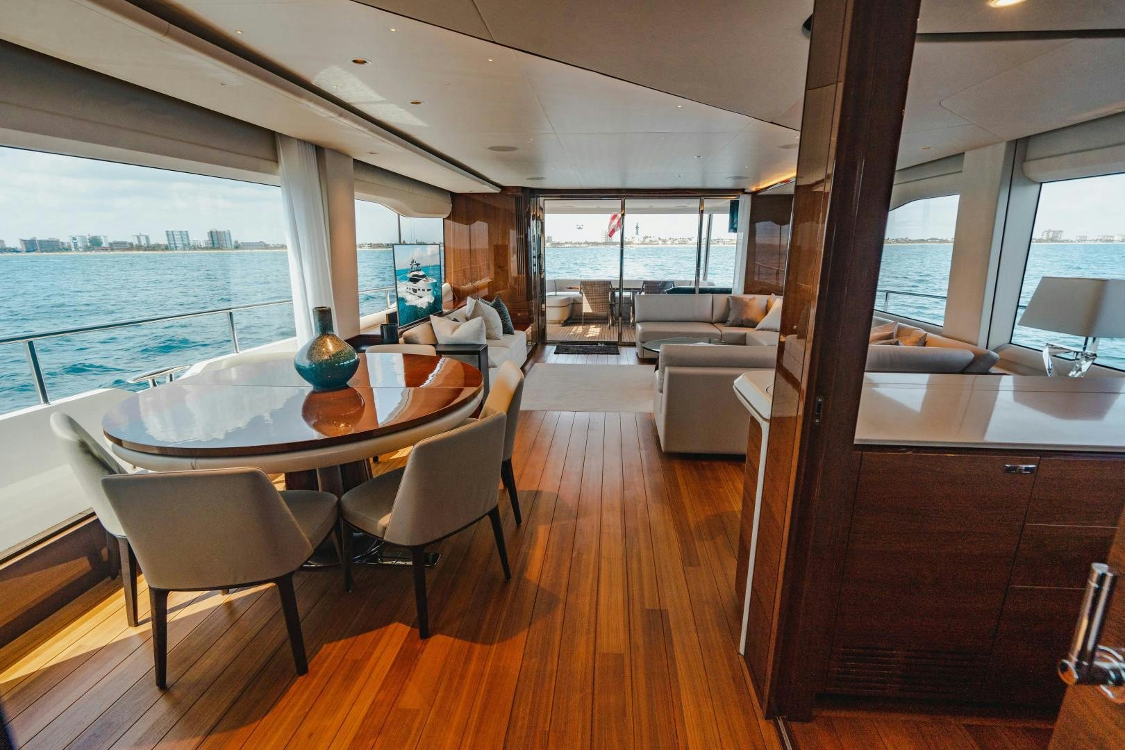 a large living room with a wood floor and a large window aboard KAOS Yacht for Sale