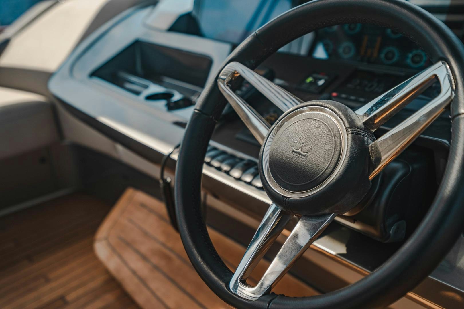 a steering wheel and dashboard of a car aboard KAOS Yacht for Sale