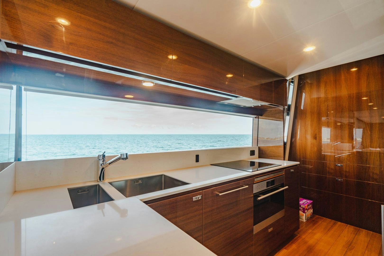 a kitchen with a large window aboard KAOS Yacht for Sale