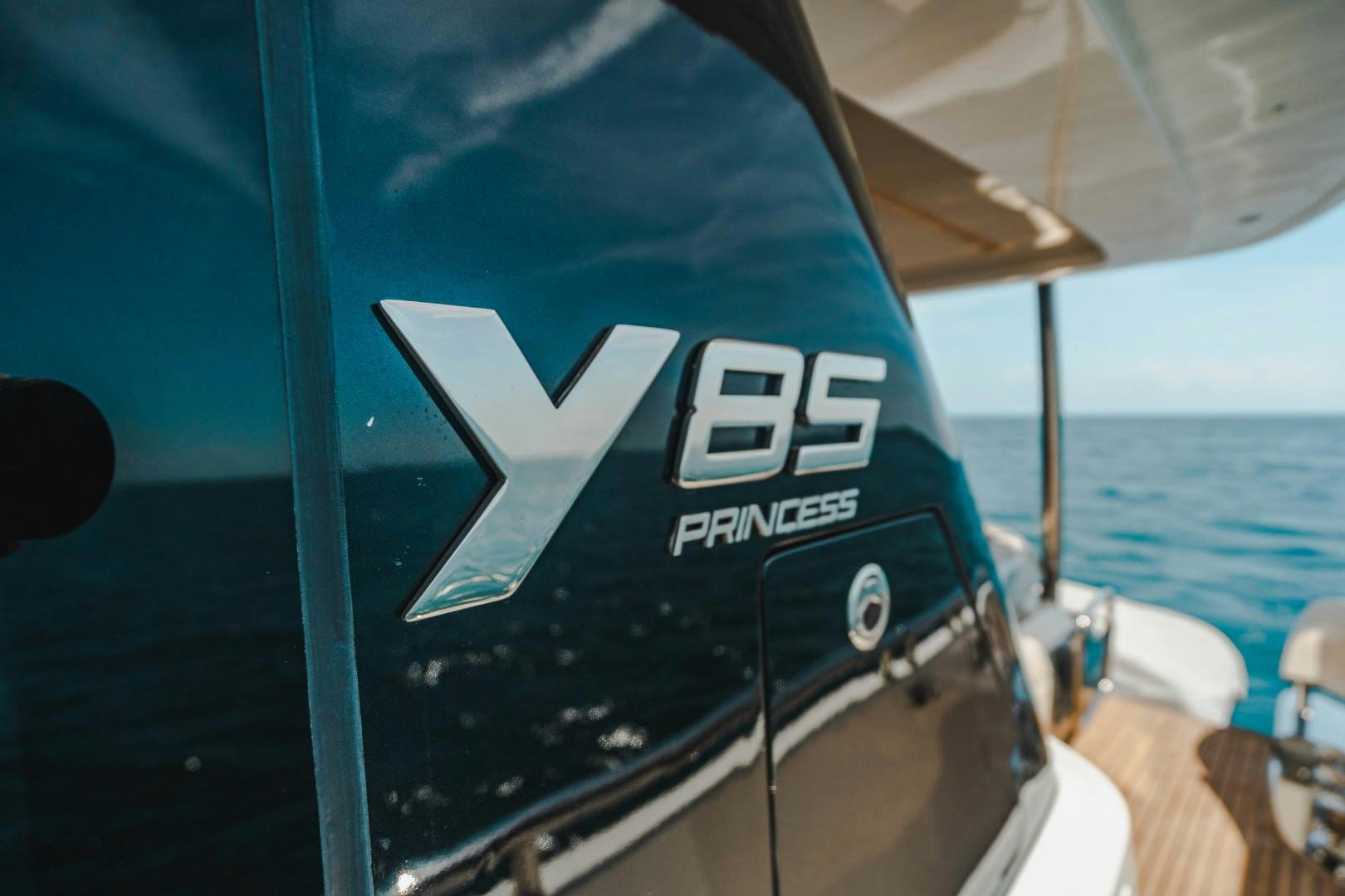 a boat with a logo on the front aboard KAOS Yacht for Sale