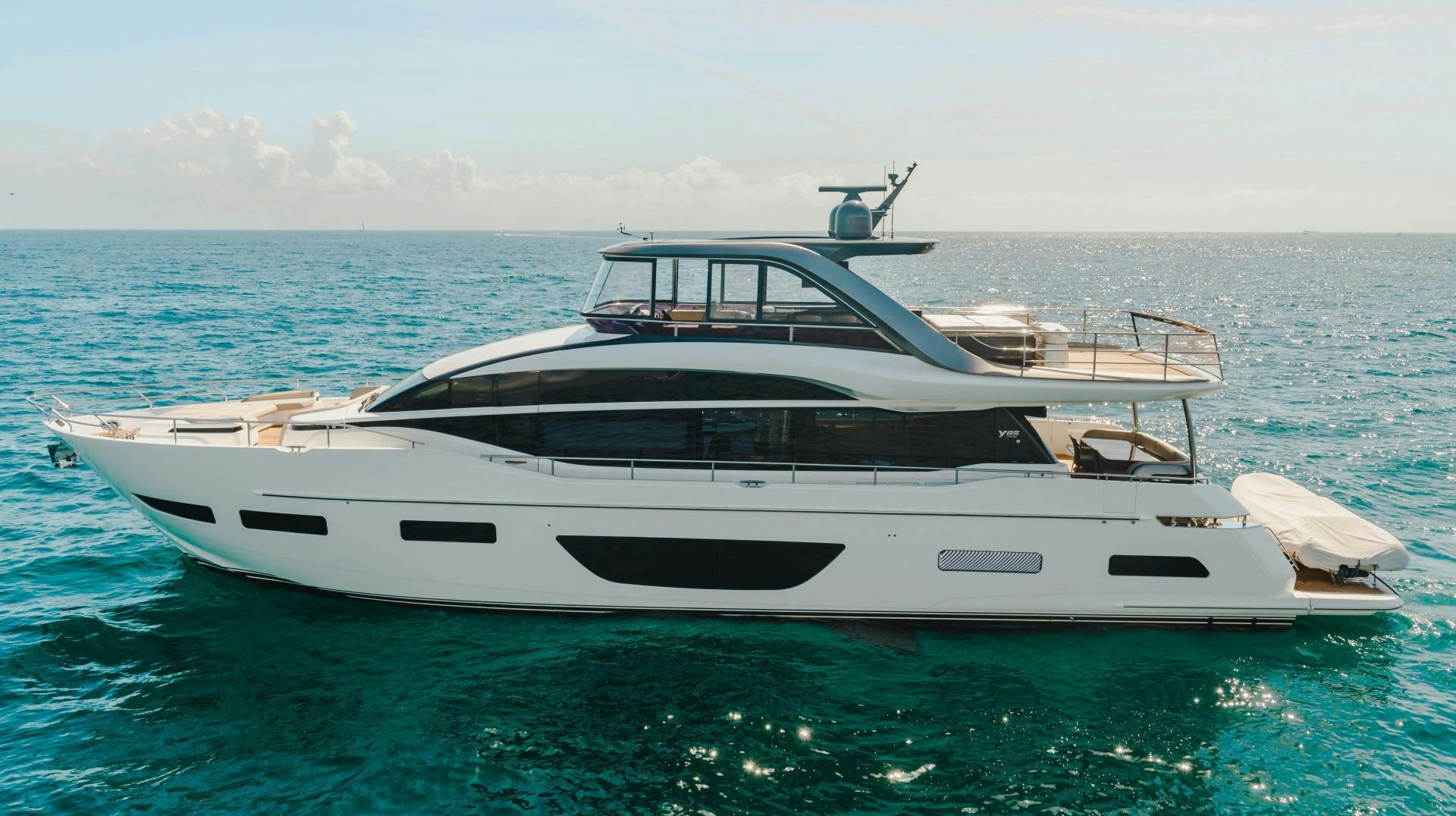 a white yacht in the water aboard KAOS Yacht for Sale