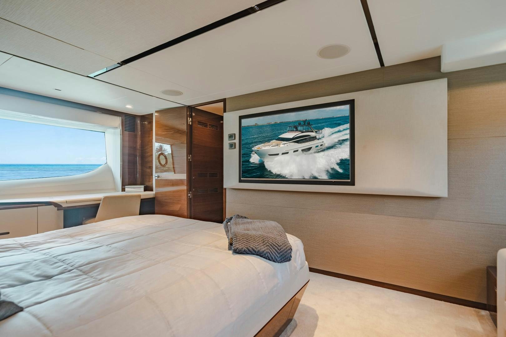 a room with a bed and a television on the wall aboard KAOS Yacht for Sale