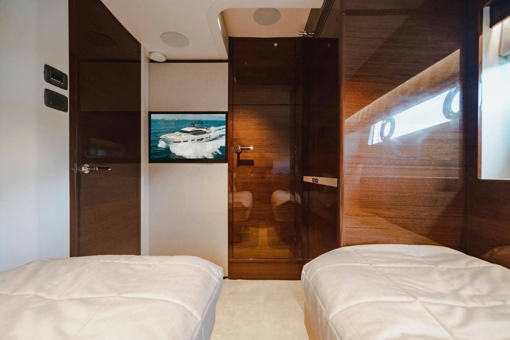 a room with a bed and a closet aboard KAOS Yacht for Sale