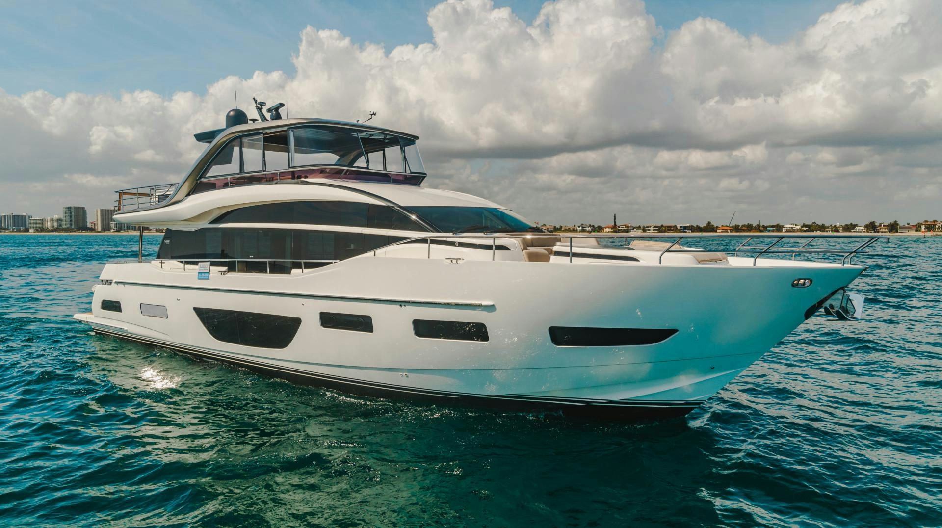 a white yacht in the water aboard KAOS Yacht for Sale