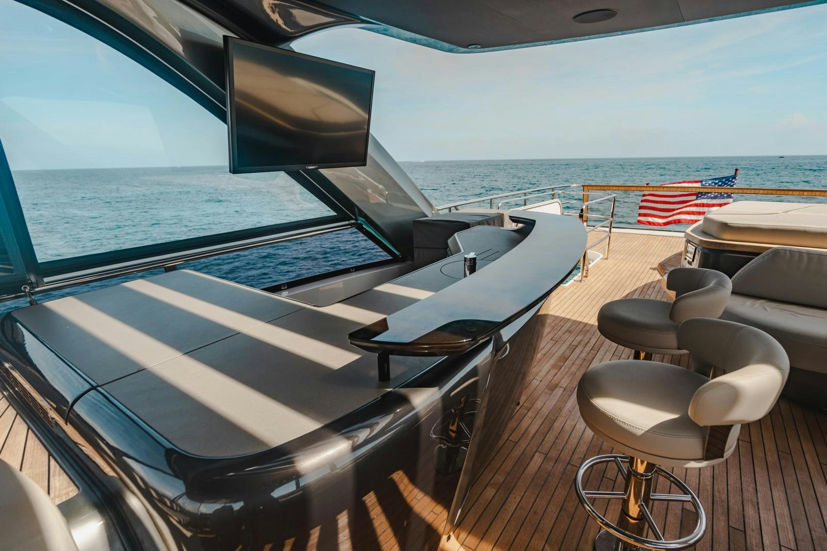 a deck with a view of the ocean and the ocean aboard KAOS Yacht for Sale