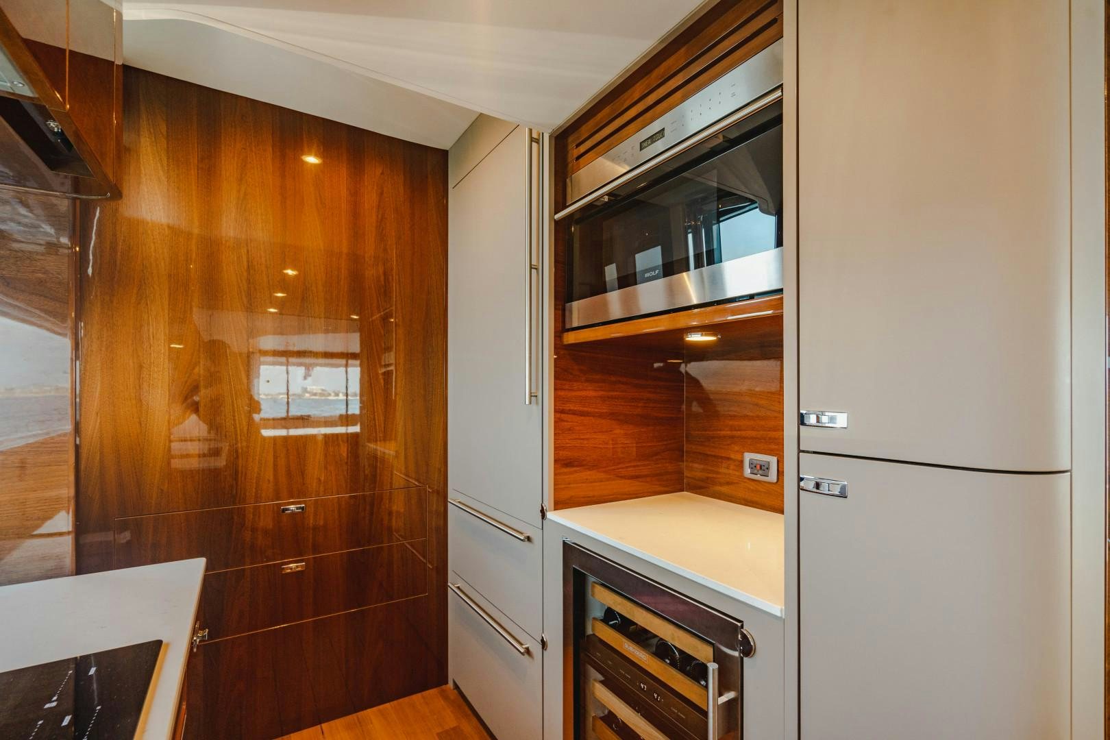 a kitchen with wooden cabinets aboard KAOS Yacht for Sale