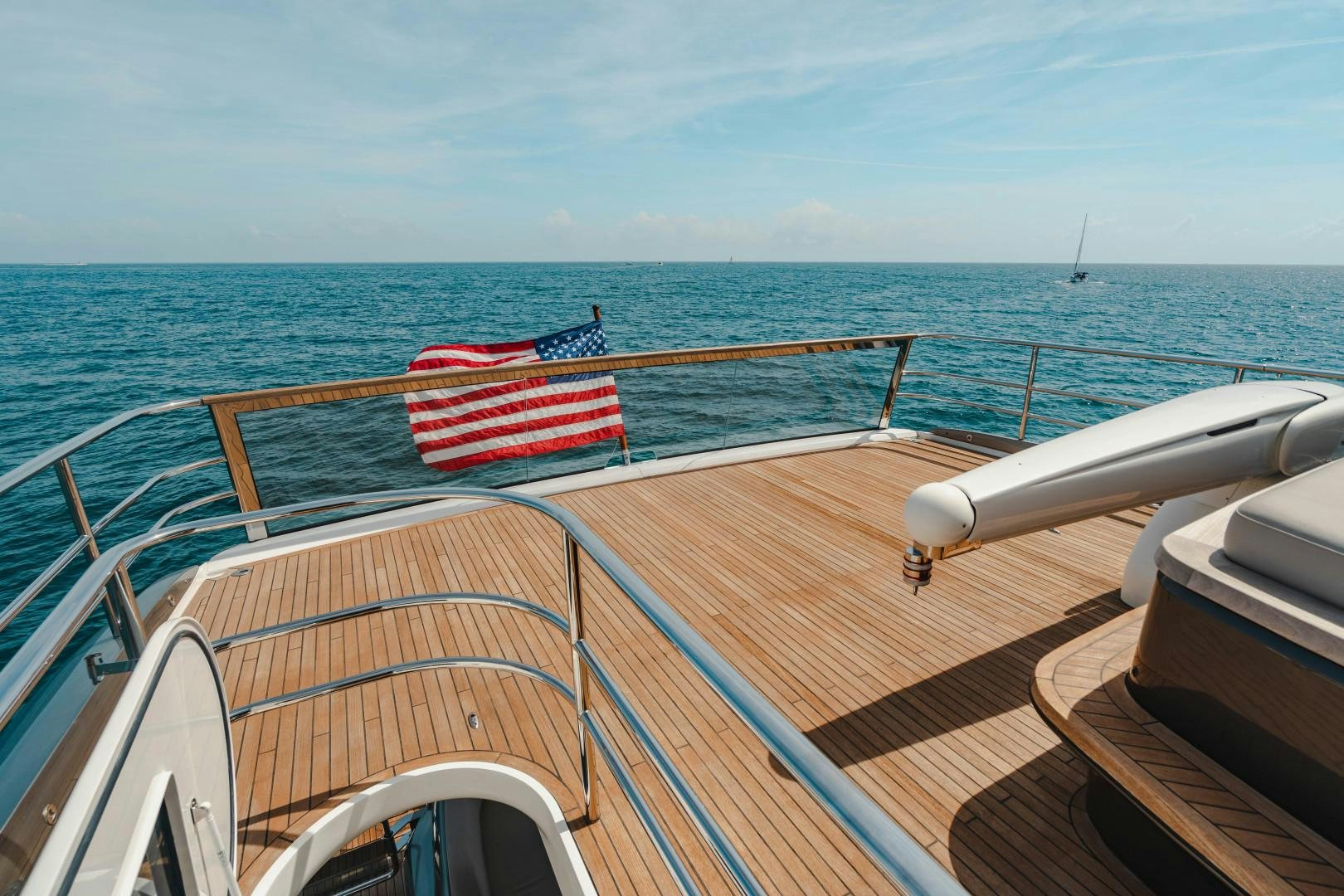 a boat with a flag on the front aboard KAOS Yacht for Sale