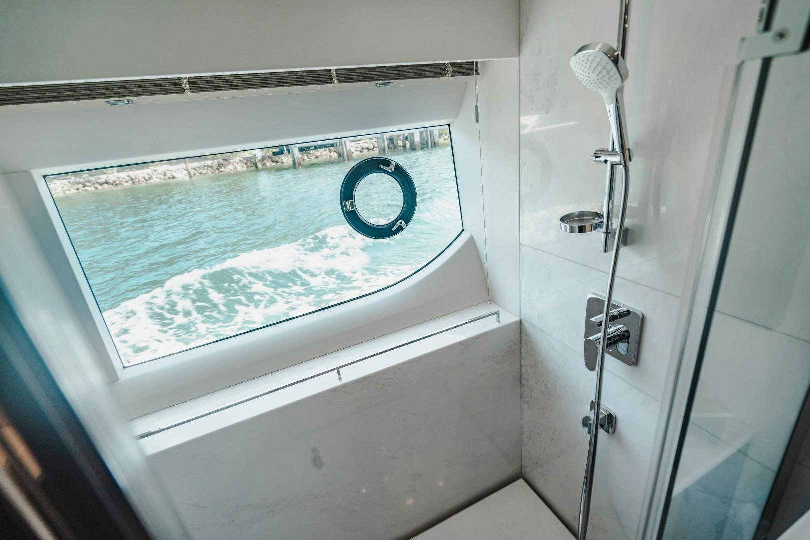a bathtub with a shower head aboard KAOS Yacht for Sale
