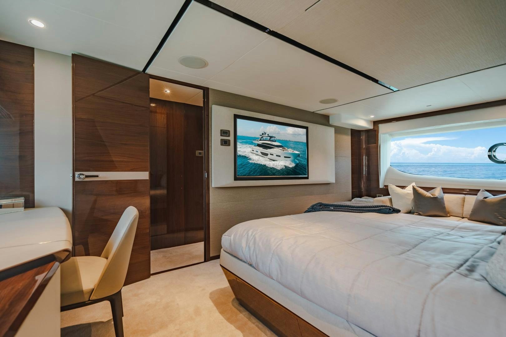 a bedroom with a bed and a desk aboard KAOS Yacht for Sale