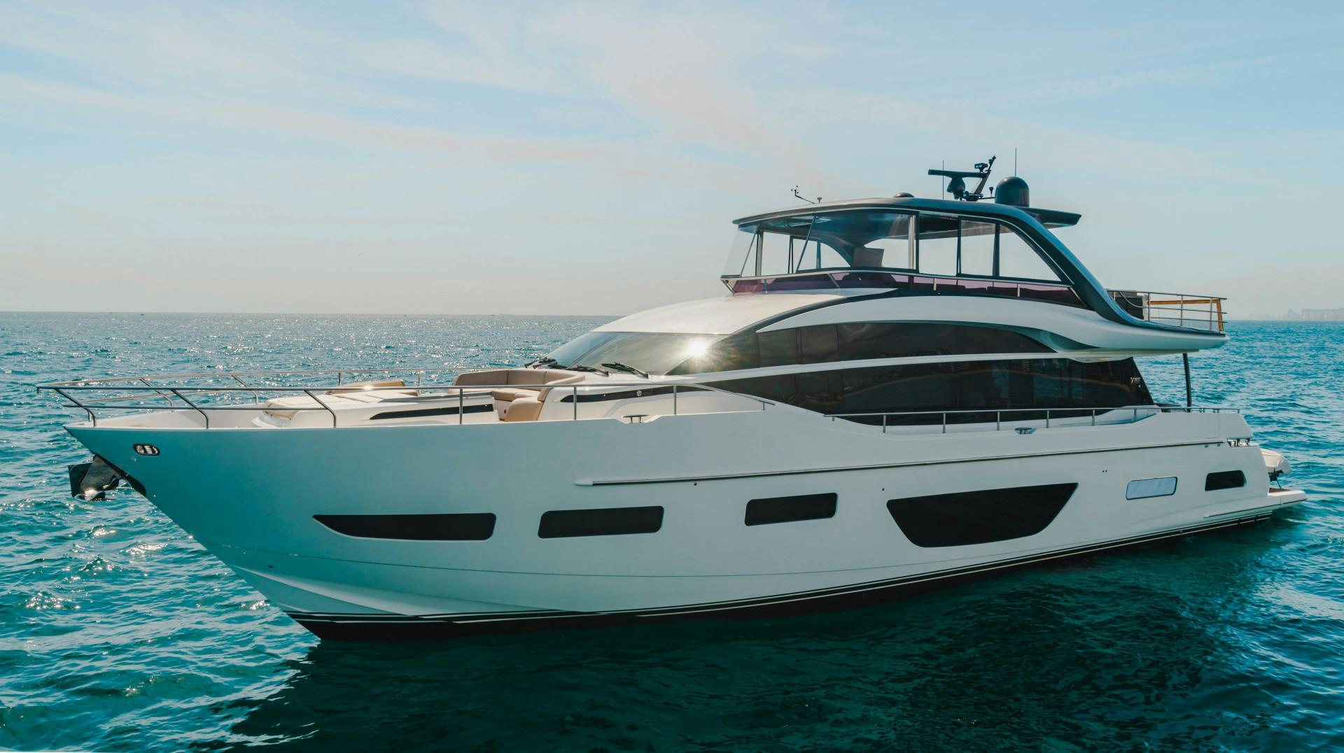 a white yacht in the water aboard KAOS Yacht for Sale