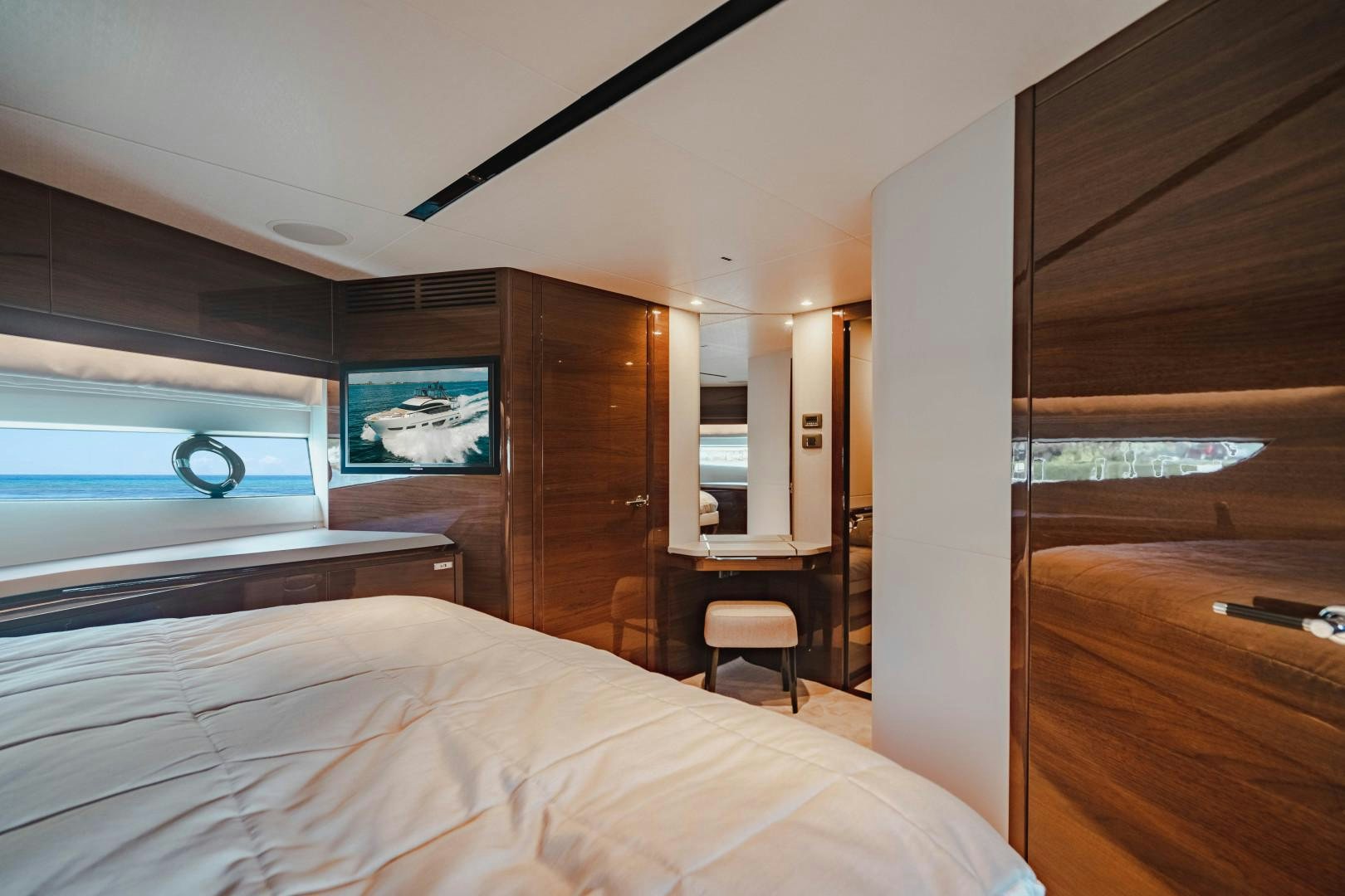 a bedroom with a bed and a desk aboard KAOS Yacht for Sale