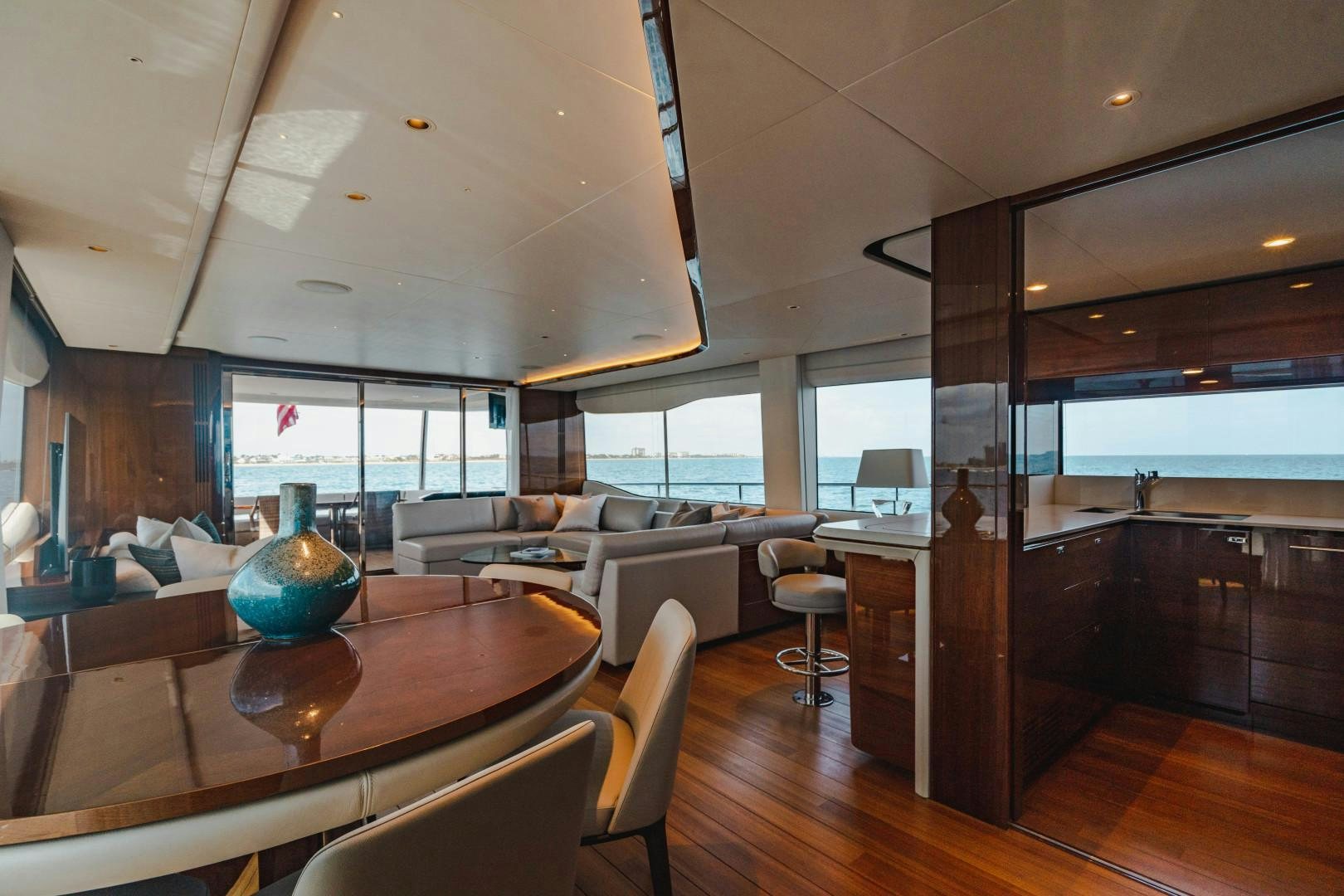 a large room with a large window and a large table with chairs aboard KAOS Yacht for Sale