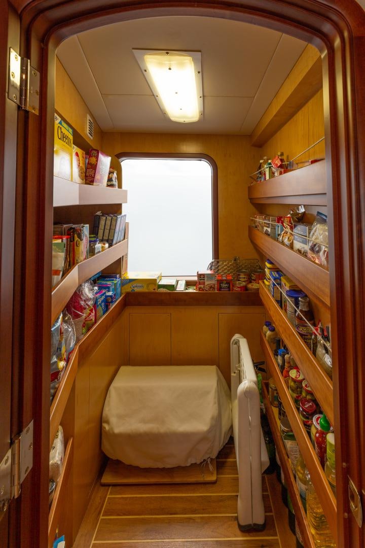 a room with shelves and shelves aboard ISLANDER Yacht for Sale