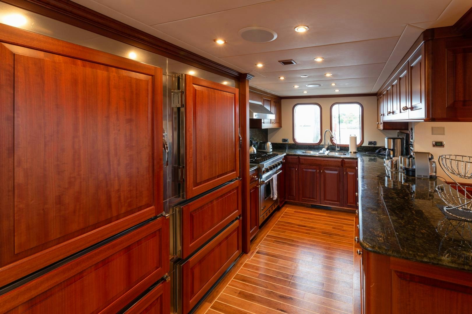 a kitchen with wooden cabinets aboard ISLANDER Yacht for Sale