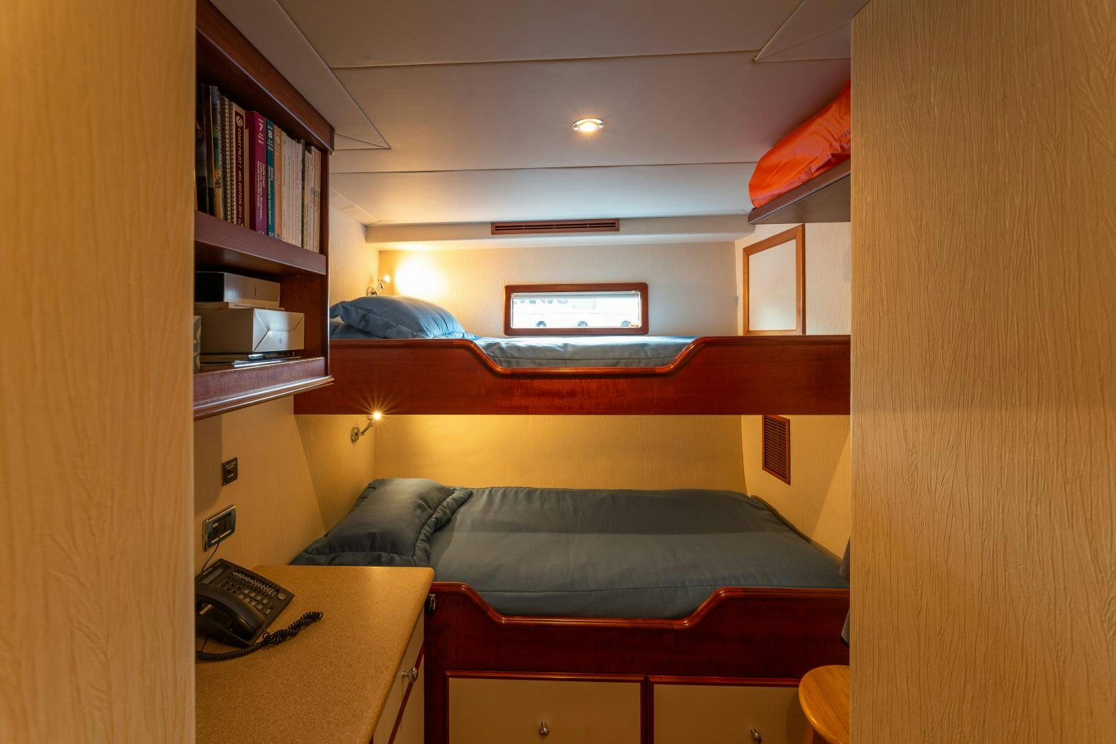 a bedroom with a desk and a bed aboard ISLANDER Yacht for Sale