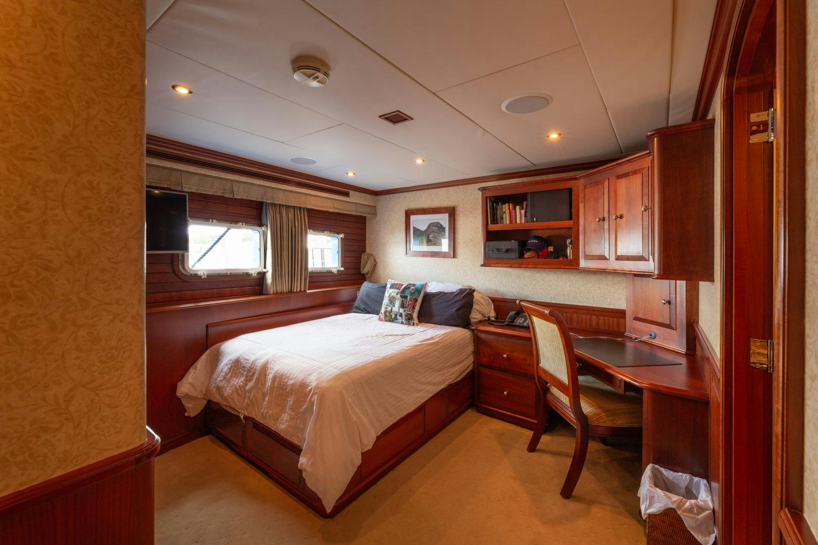 a bedroom with a bed and desk aboard ISLANDER Yacht for Sale