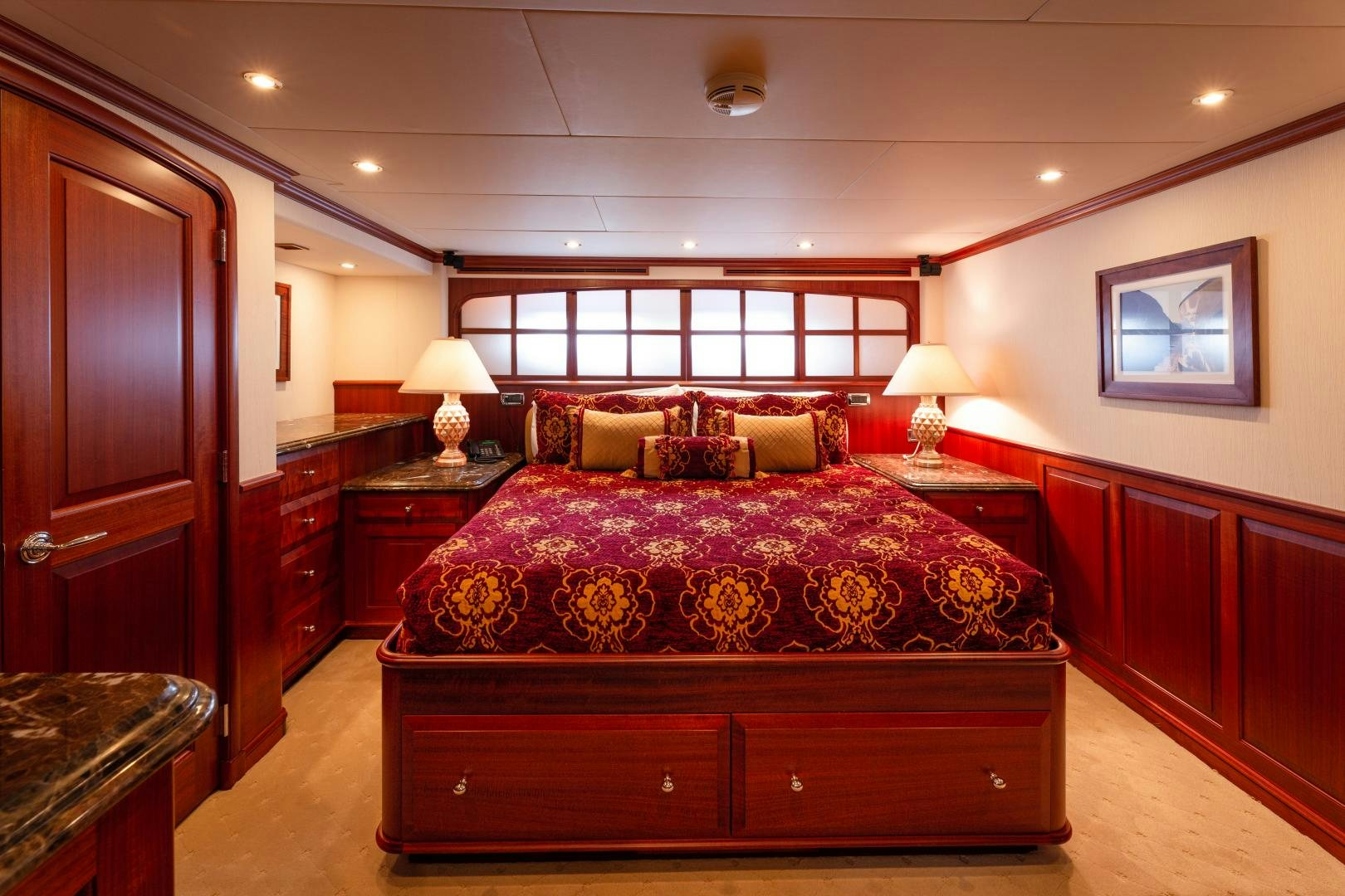 a bedroom with a bed and a dresser aboard ISLANDER Yacht for Sale