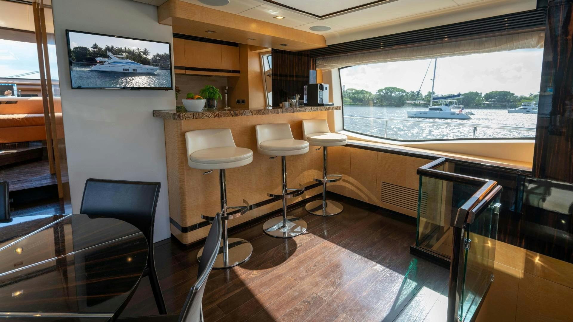 a room with a table chairs and a window aboard PHOENIX Yacht for Sale