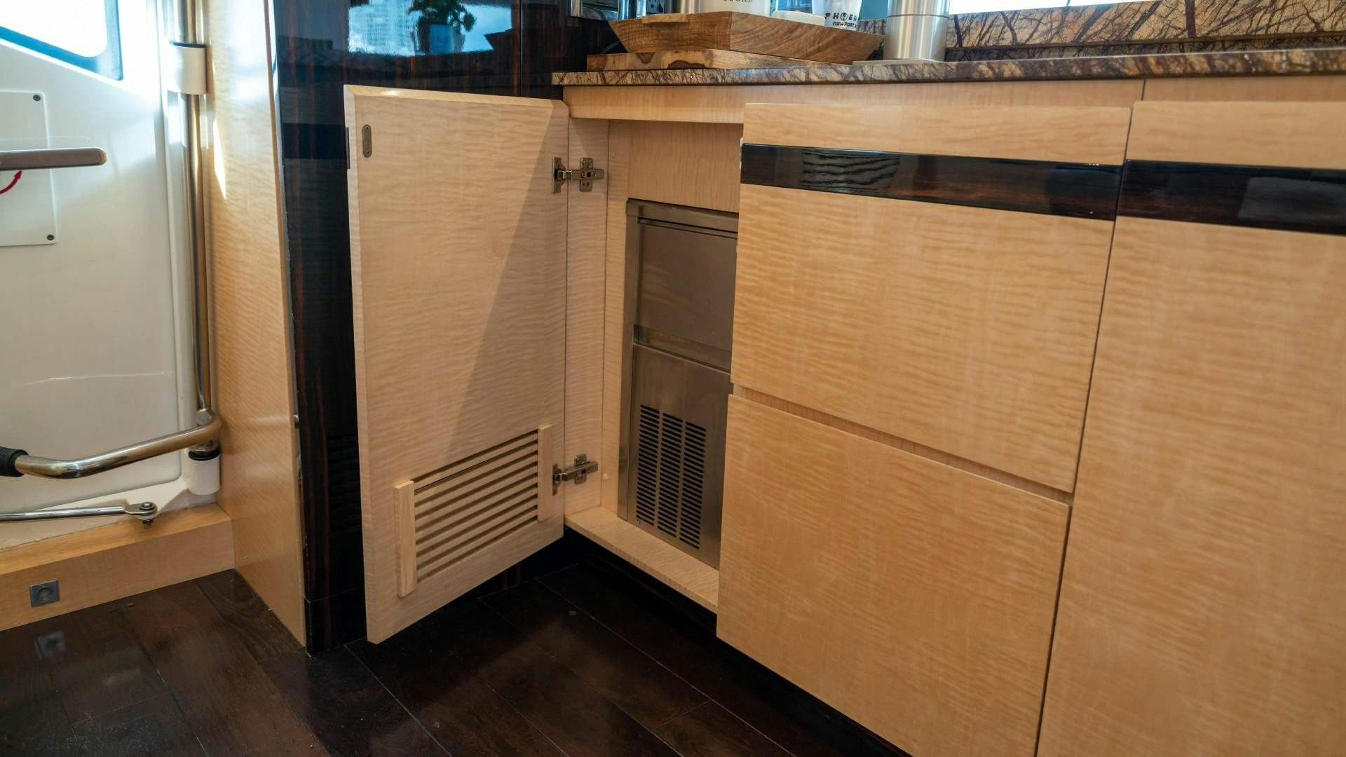 a room with wooden cabinets aboard PHOENIX Yacht for Sale
