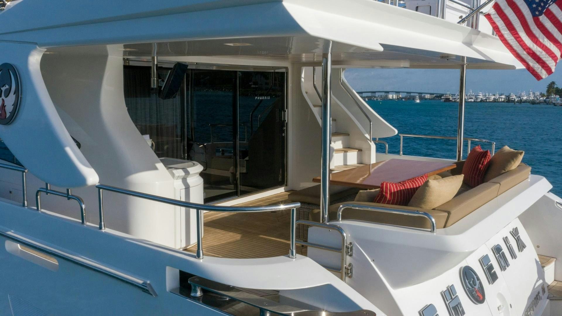 a boat with a flag on the front aboard PHOENIX Yacht for Sale