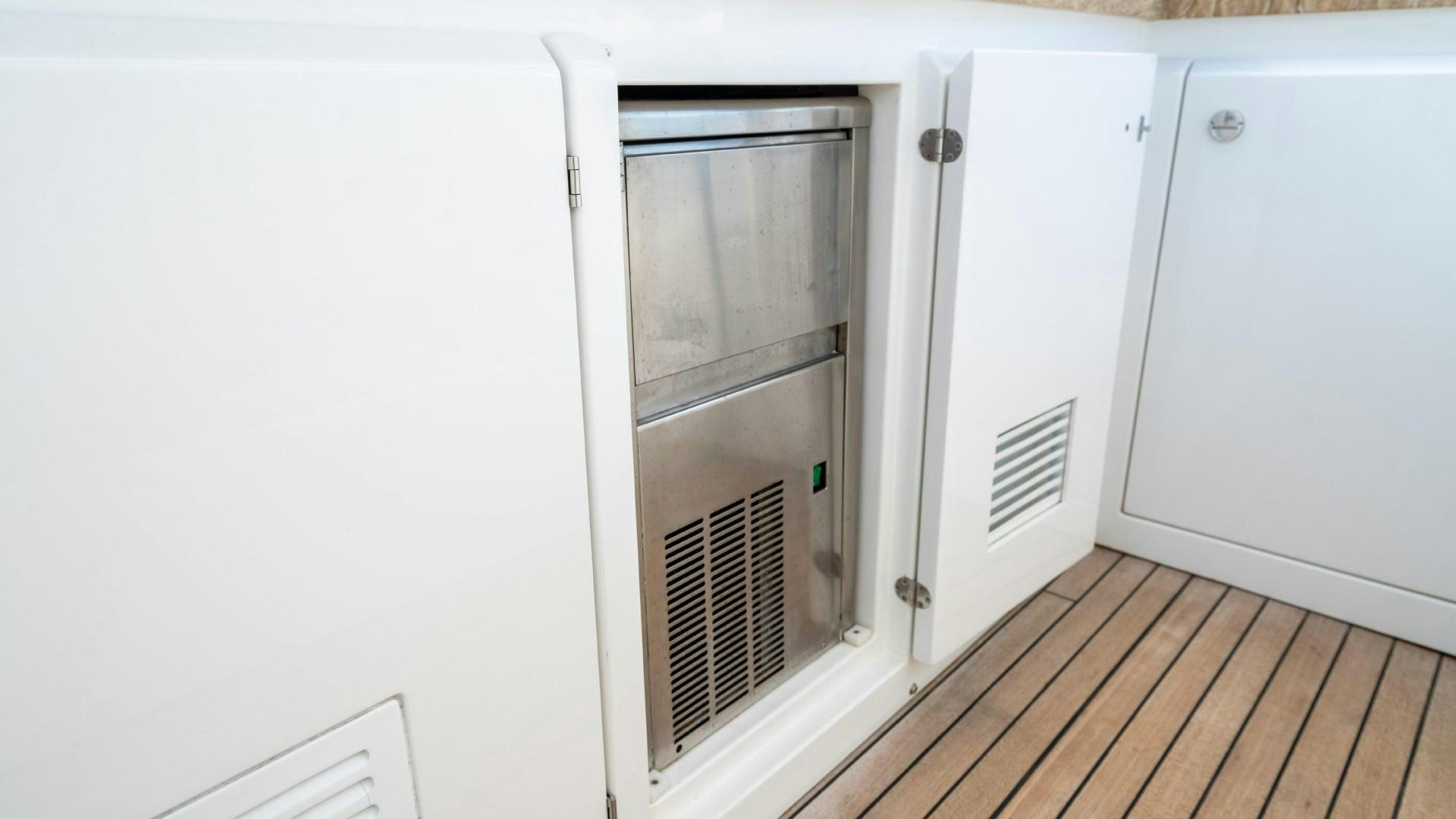a kitchen with white cabinets aboard PHOENIX Yacht for Sale
