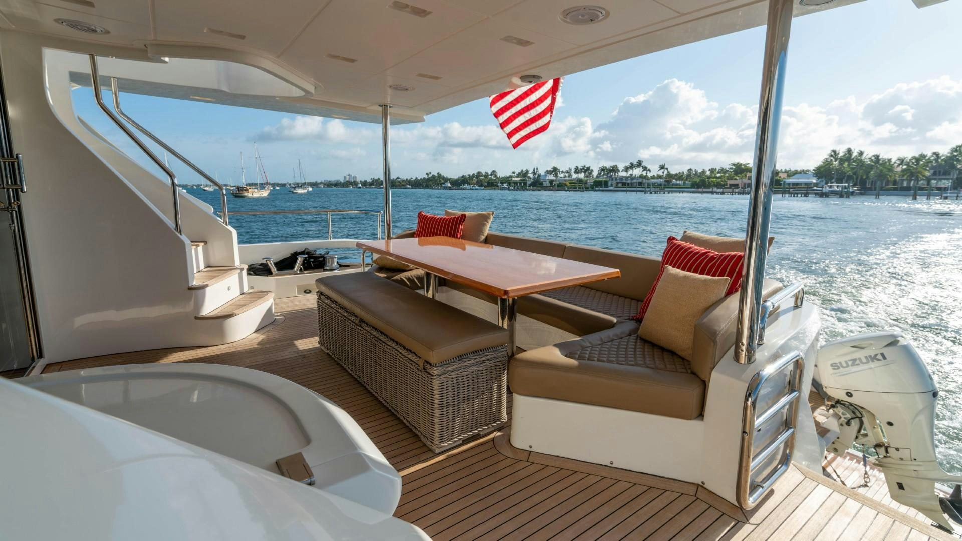 a boat with a flag on the deck aboard PHOENIX Yacht for Sale