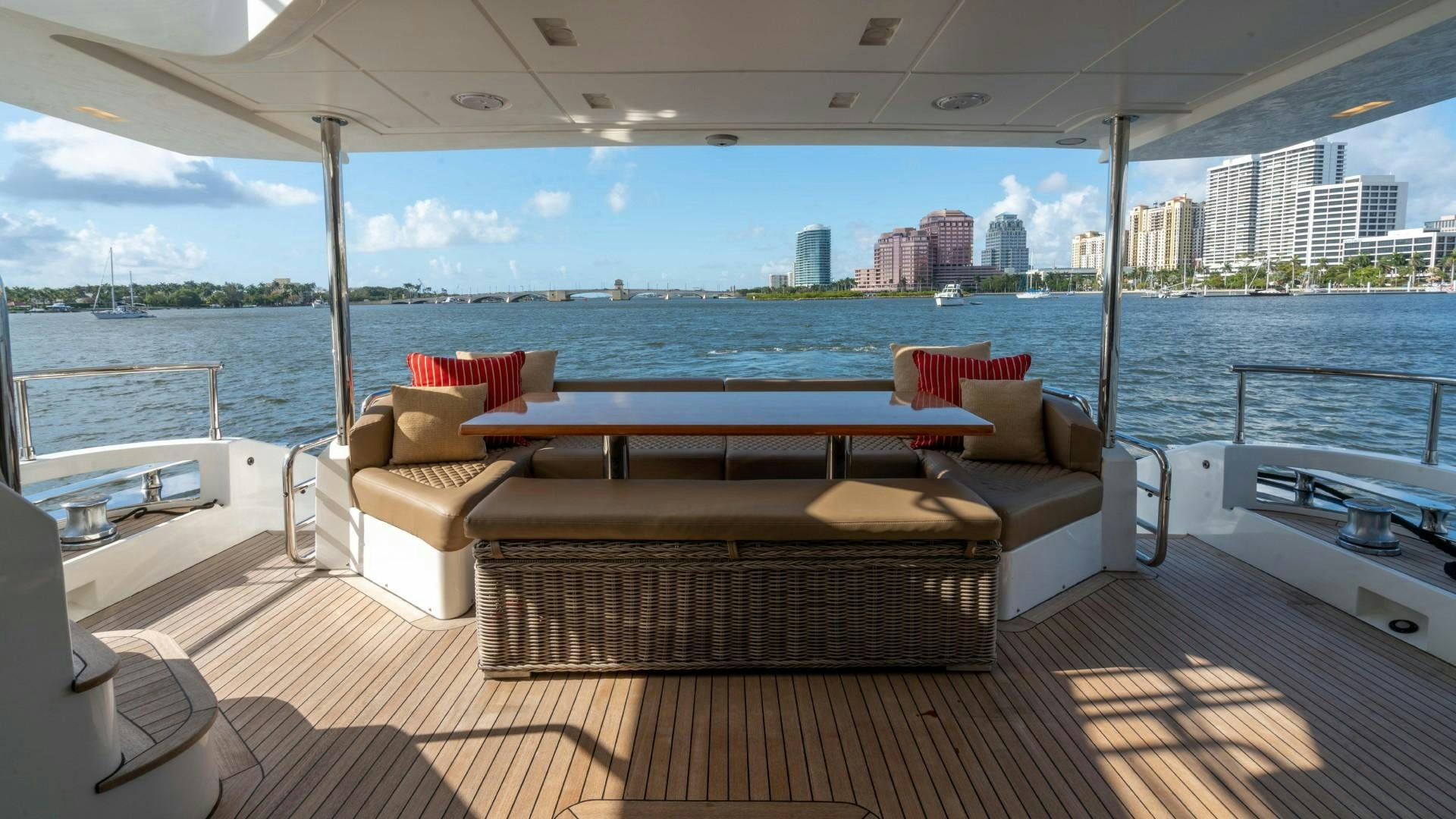 a room with a couch and a table and a view of a city aboard PHOENIX Yacht for Sale