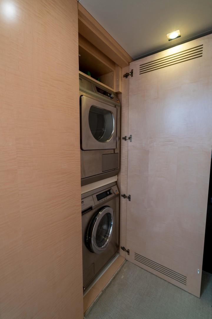 a closet with a washer and dryer in it aboard PHOENIX Yacht for Sale