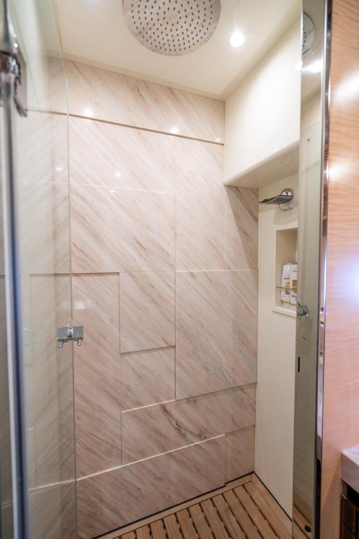 a shower with a tile wall aboard PHOENIX Yacht for Sale