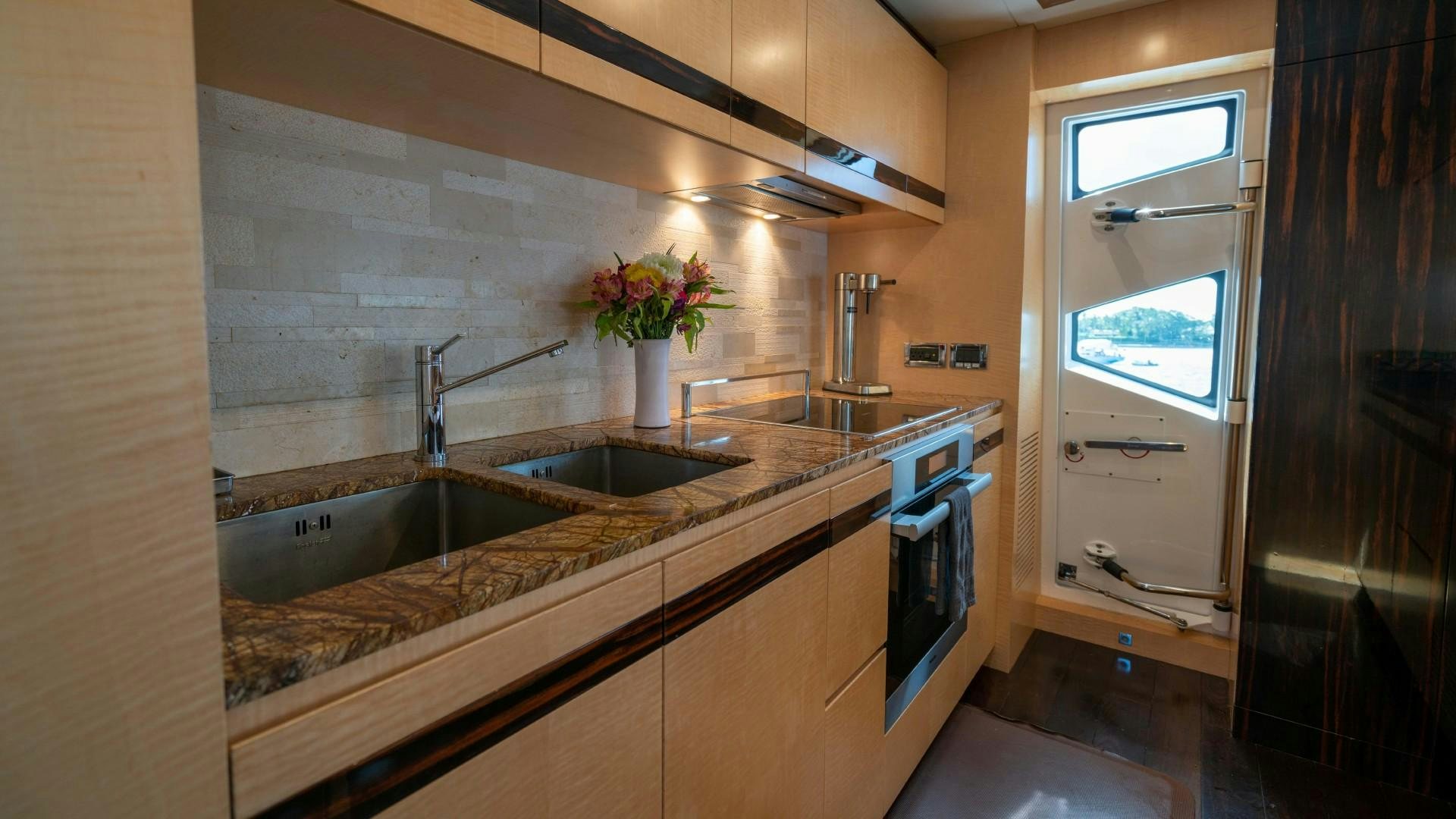 a kitchen with a sink and a window aboard PHOENIX Yacht for Sale