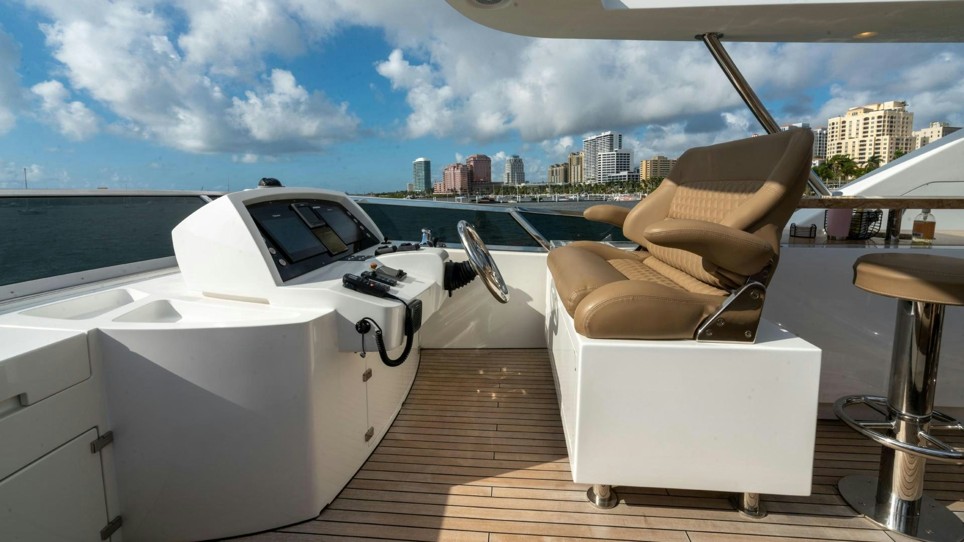 a lounge chair on a deck overlooking a city aboard PHOENIX Yacht for Sale