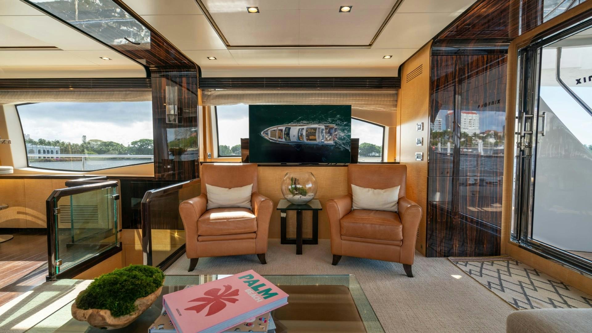 a room with a couch and a tv aboard PHOENIX Yacht for Sale