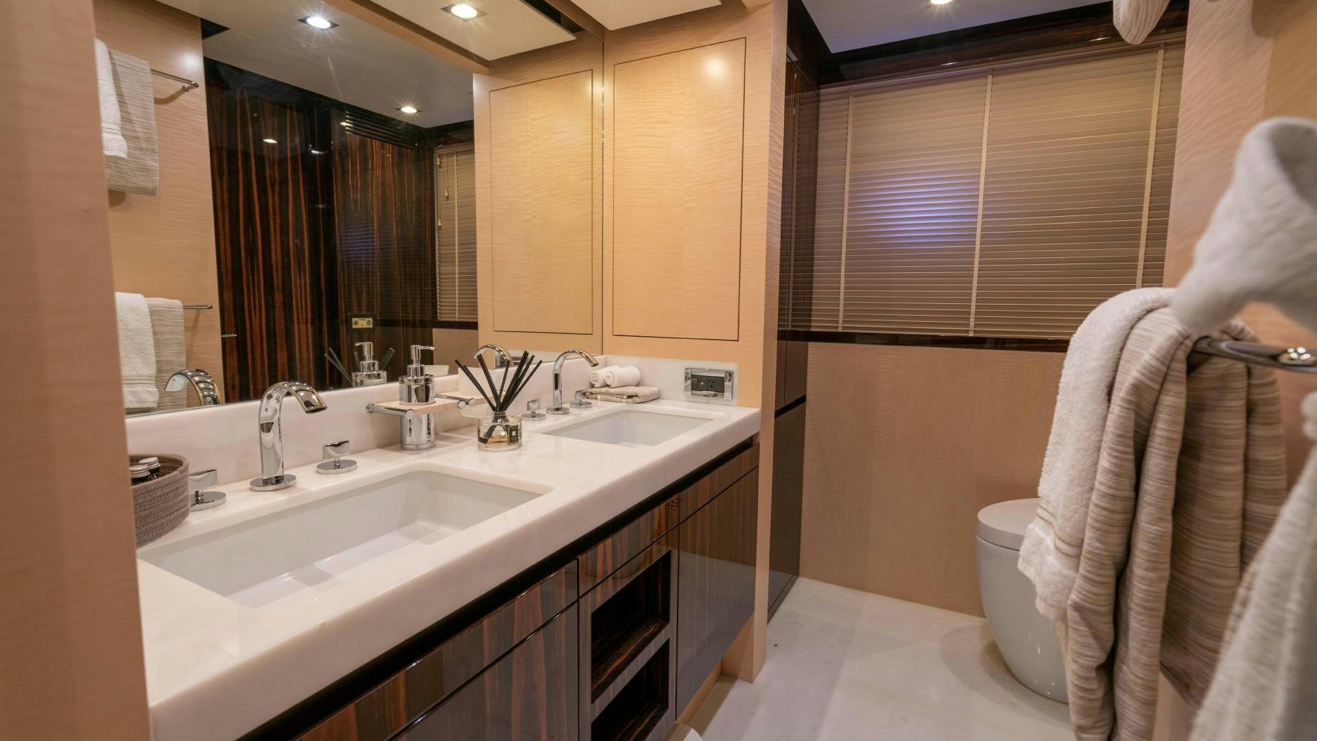 a bathroom with a large mirror aboard PHOENIX Yacht for Sale