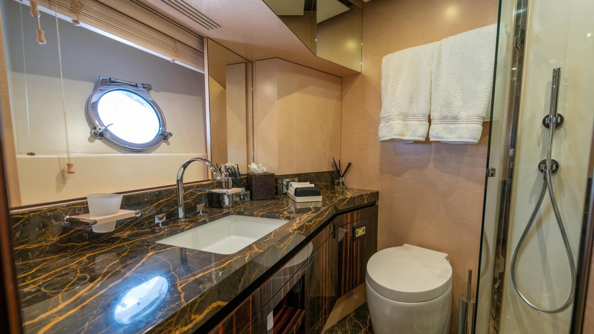 a bathroom with a large mirror aboard PHOENIX Yacht for Sale
