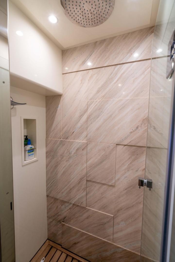 a shower with a tile wall aboard PHOENIX Yacht for Sale