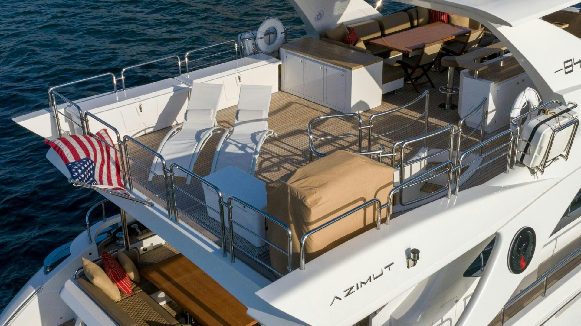 a boat with a flag on the deck aboard PHOENIX Yacht for Sale