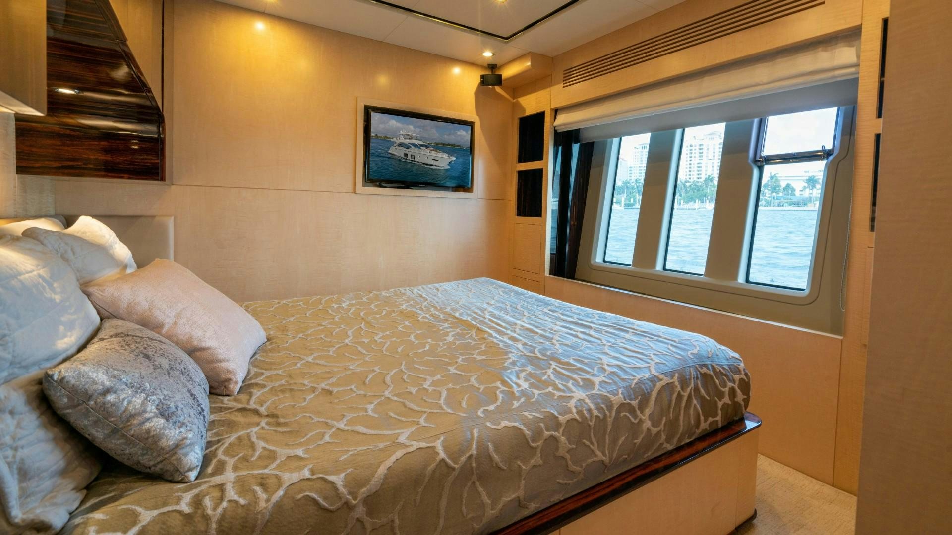 a bed with a white comforter aboard PHOENIX Yacht for Sale