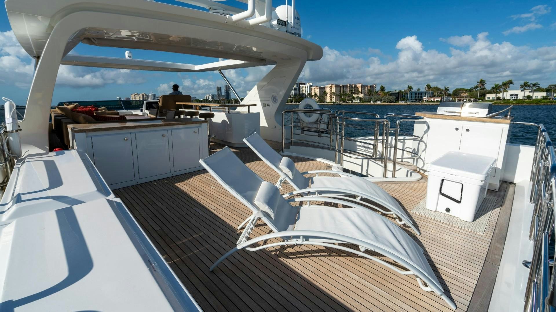a deck with a view of a city and water aboard PHOENIX Yacht for Sale