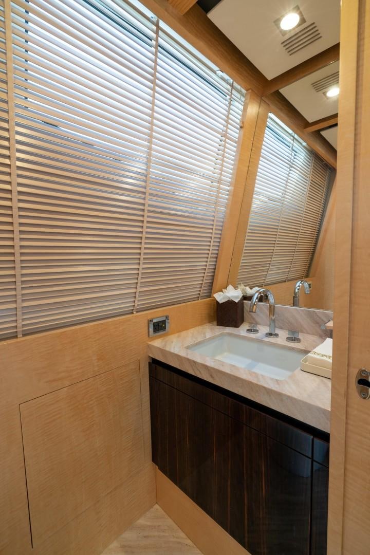a bathroom with a sink and a mirror aboard PHOENIX Yacht for Sale