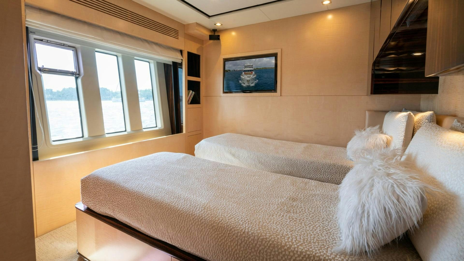 a bed with white pillows aboard PHOENIX Yacht for Sale