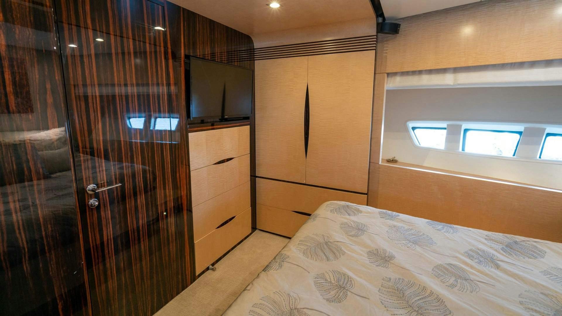 a room with a bed and a closet aboard PHOENIX Yacht for Sale