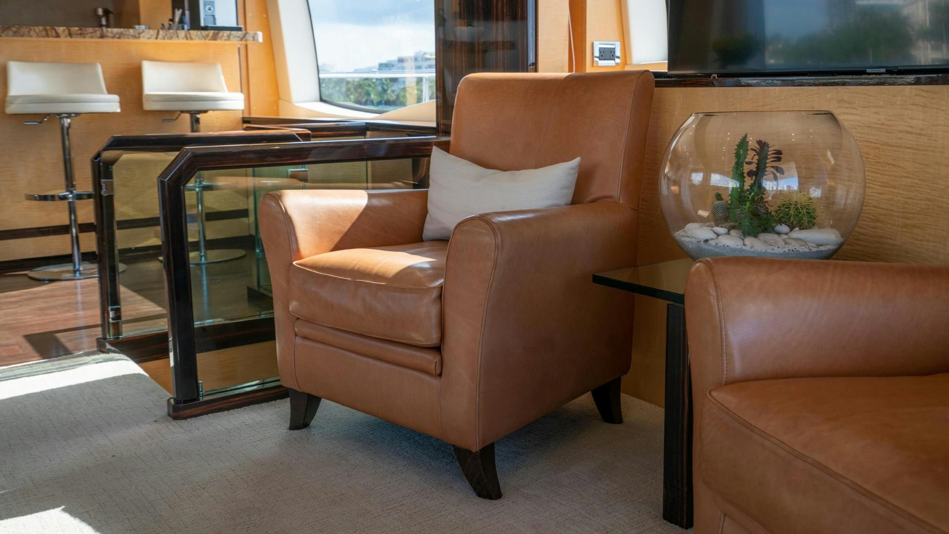 a brown leather chair in a room aboard PHOENIX Yacht for Sale