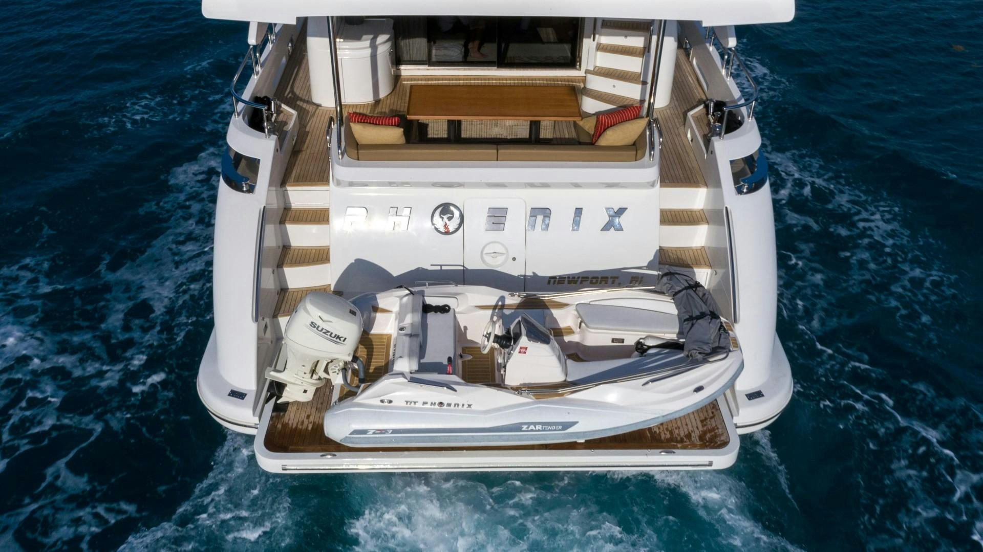 a white boat on the water aboard PHOENIX Yacht for Sale