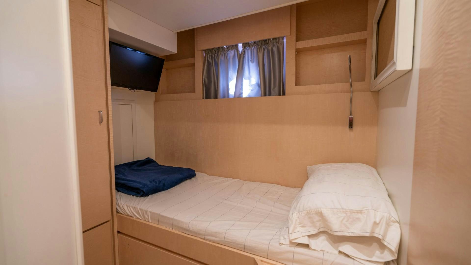 a room with a bed and a window aboard PHOENIX Yacht for Sale