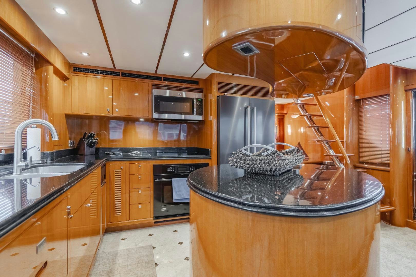 a kitchen with wooden cabinets aboard OBSESSION Yacht for Sale