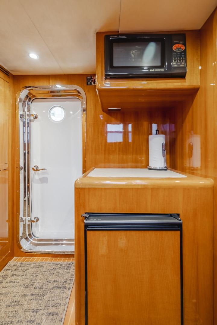 a microwave oven sits on top of a cabinet aboard OBSESSION Yacht for Sale