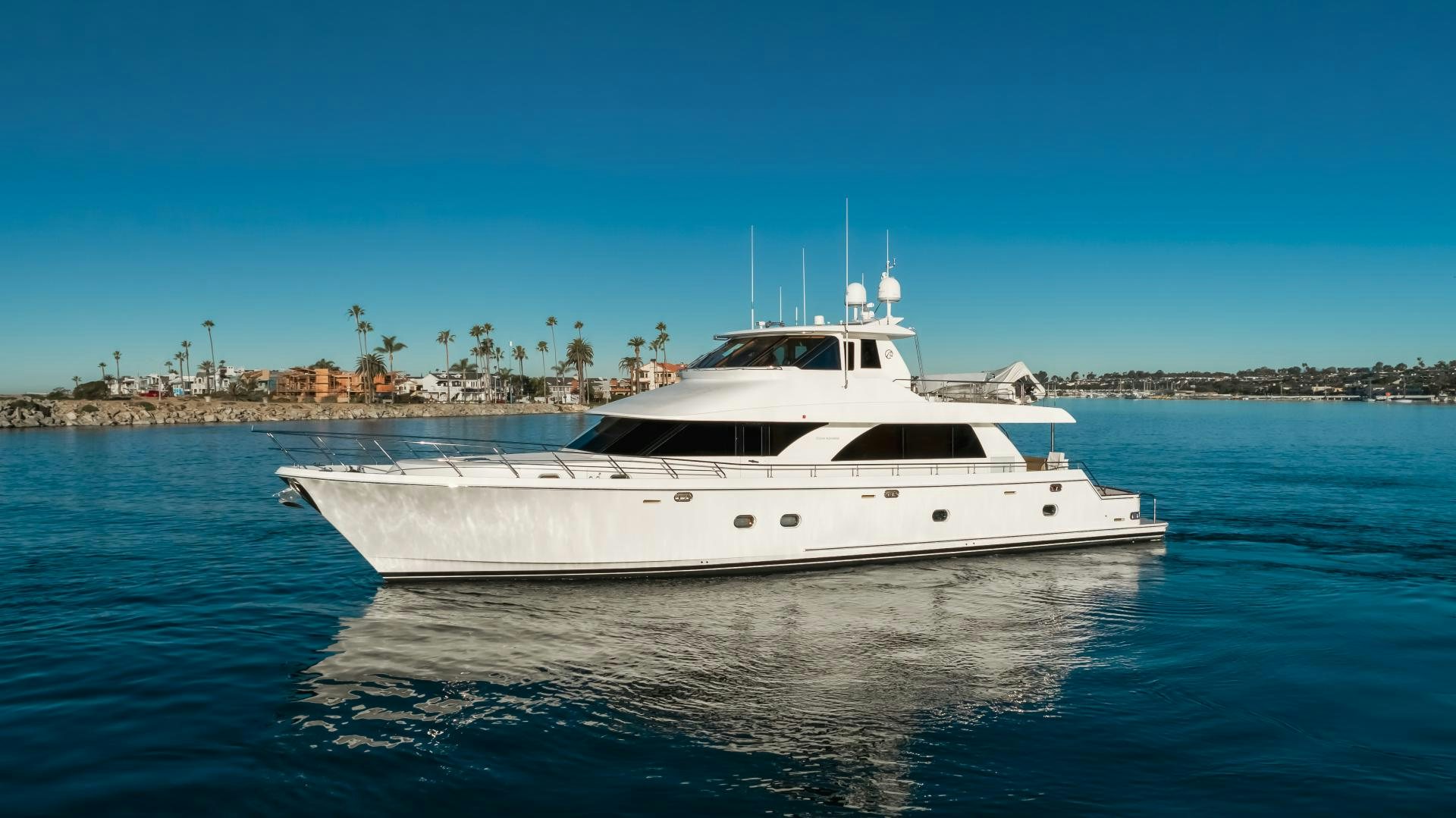 a white yacht in the water aboard OBSESSION Yacht for Sale