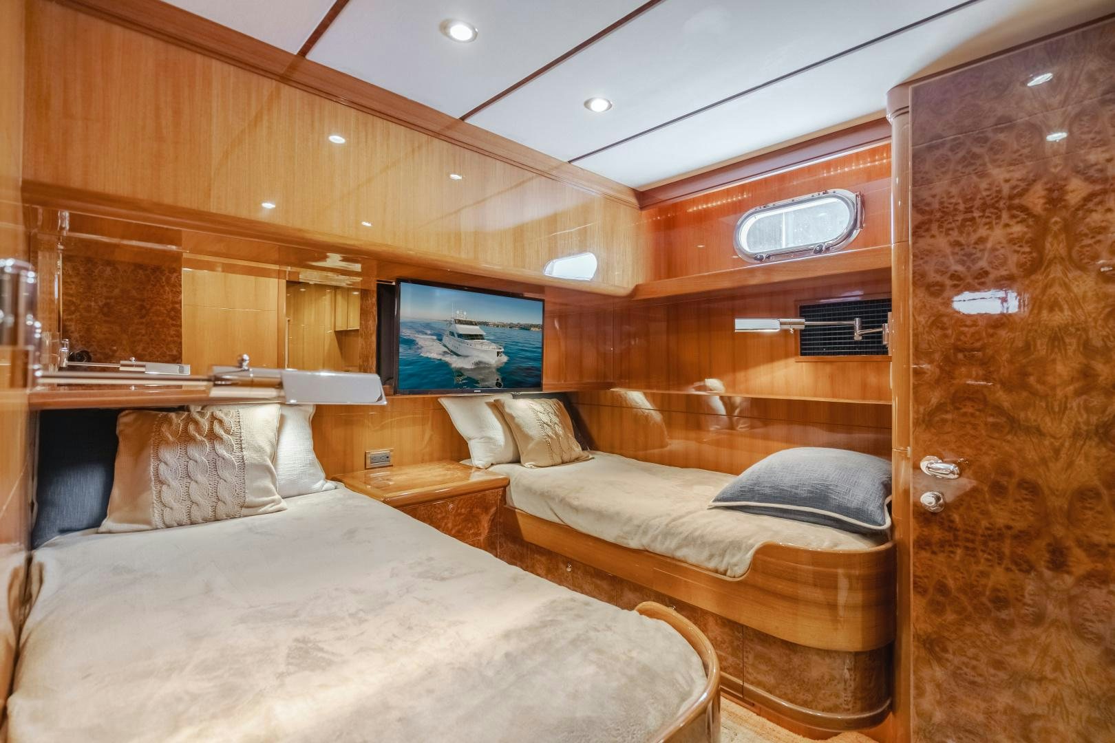a room with a bed and a wood wall aboard OBSESSION Yacht for Sale